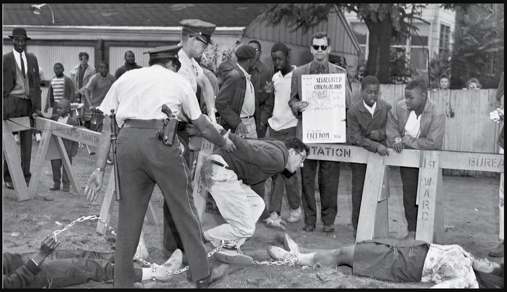 Bernard Sanders, chained to two black women protesters, getting arrested at anti-segregation rally in Chicago, 1963.